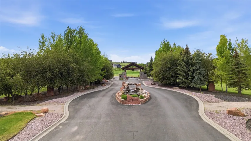 Circular driveway featuring a central multi-tiered rock waterfall