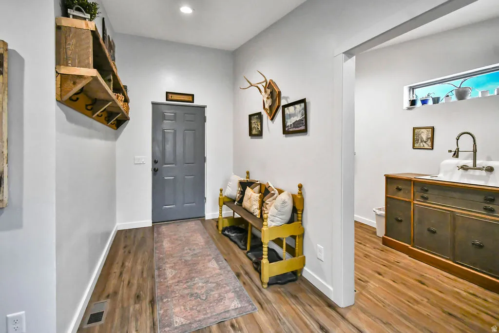 Entryway featuring wood-finish flooring, light gray walls, and a recessed light fixture