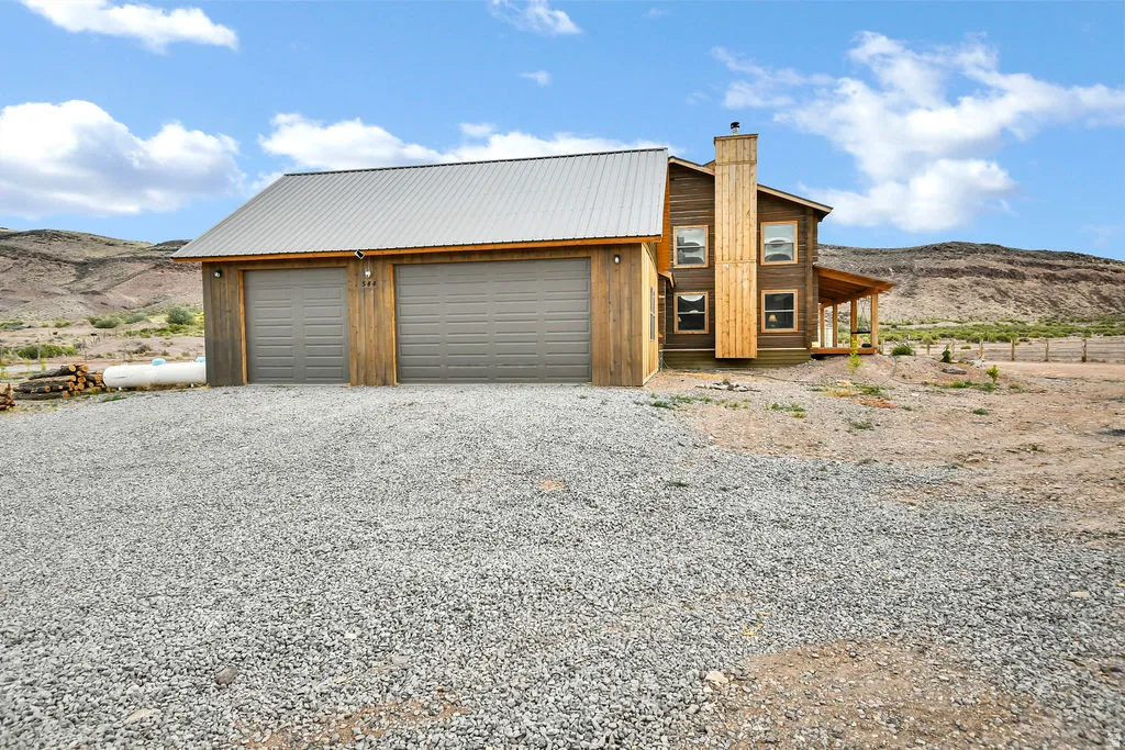 Two-car garage with wood siding and a metal roof