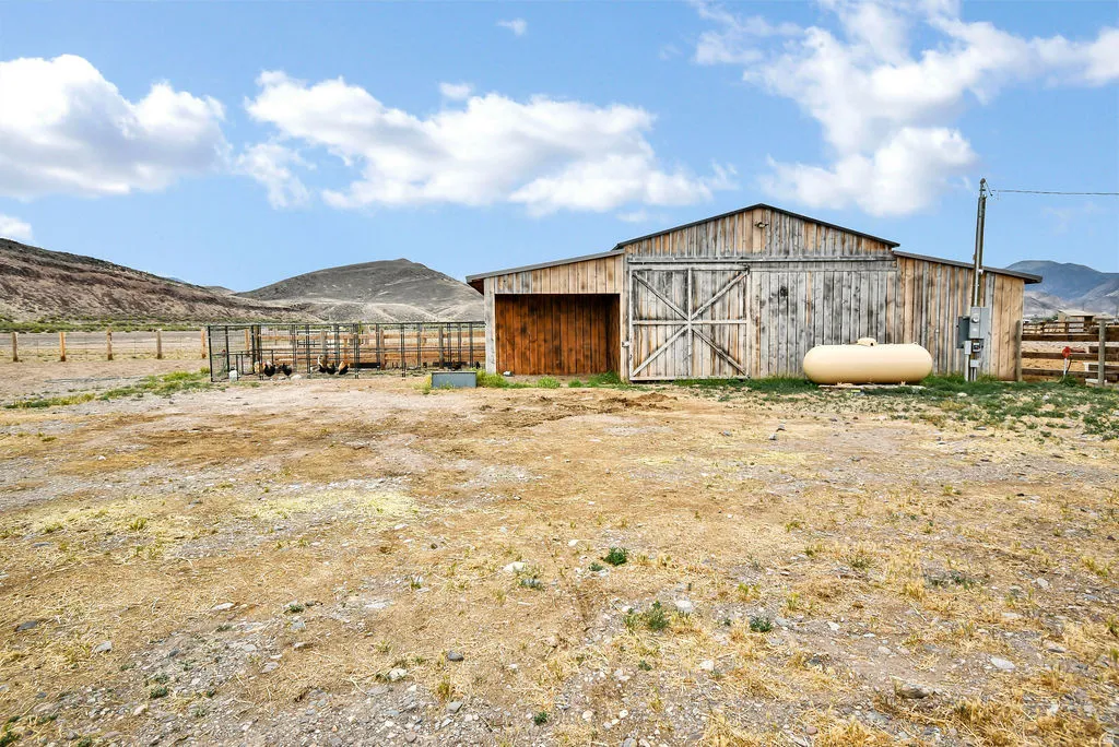 Rustic wooden barn with double doors and an additional side entrance