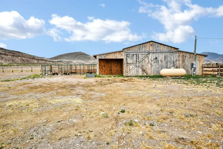 Rustic wooden barn with double doors and an additional side entrance