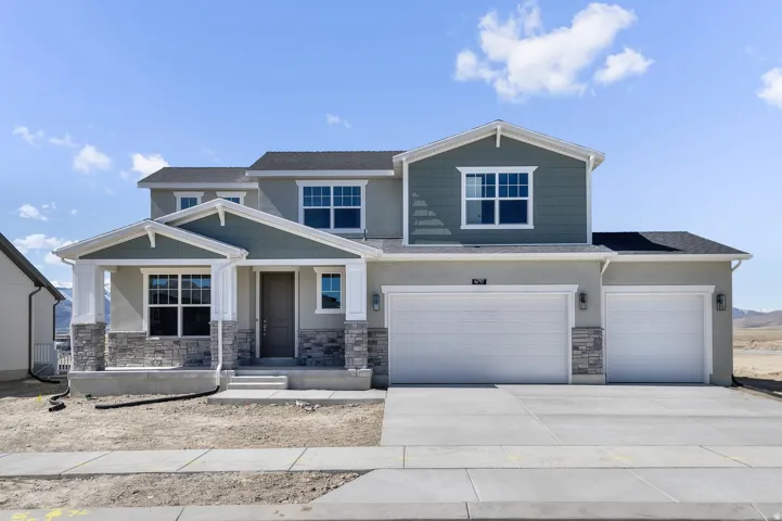 Two-story residence featuring a covered front porch, stone and siding accents, a two-car garage, and a concrete driveway