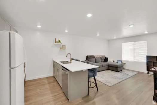 Open-concept living space featuring wood-finish flooring throughout