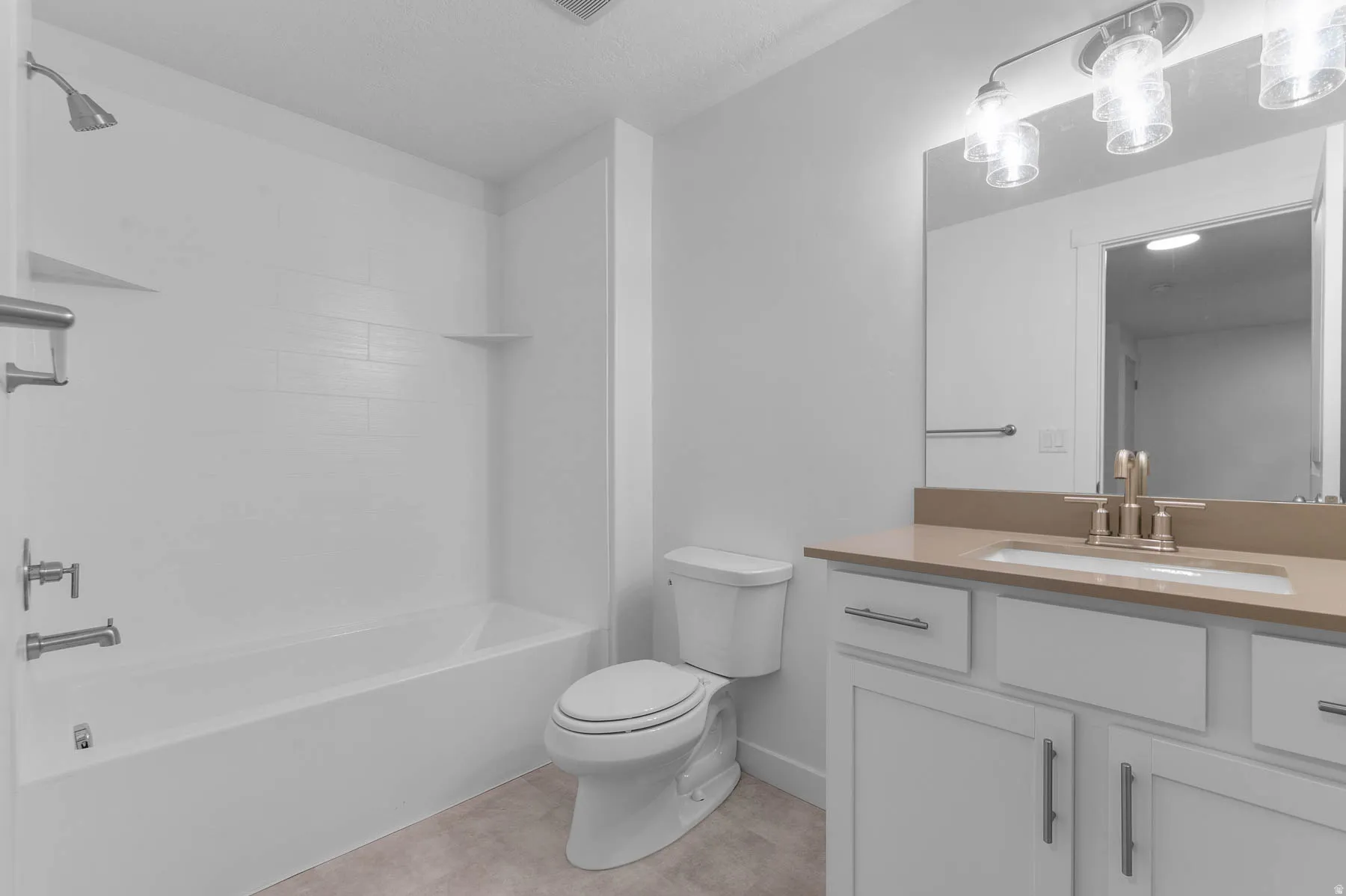 Bathroom vanity featuring a light-colored countertop, undermount sink, and brushed nickel faucet