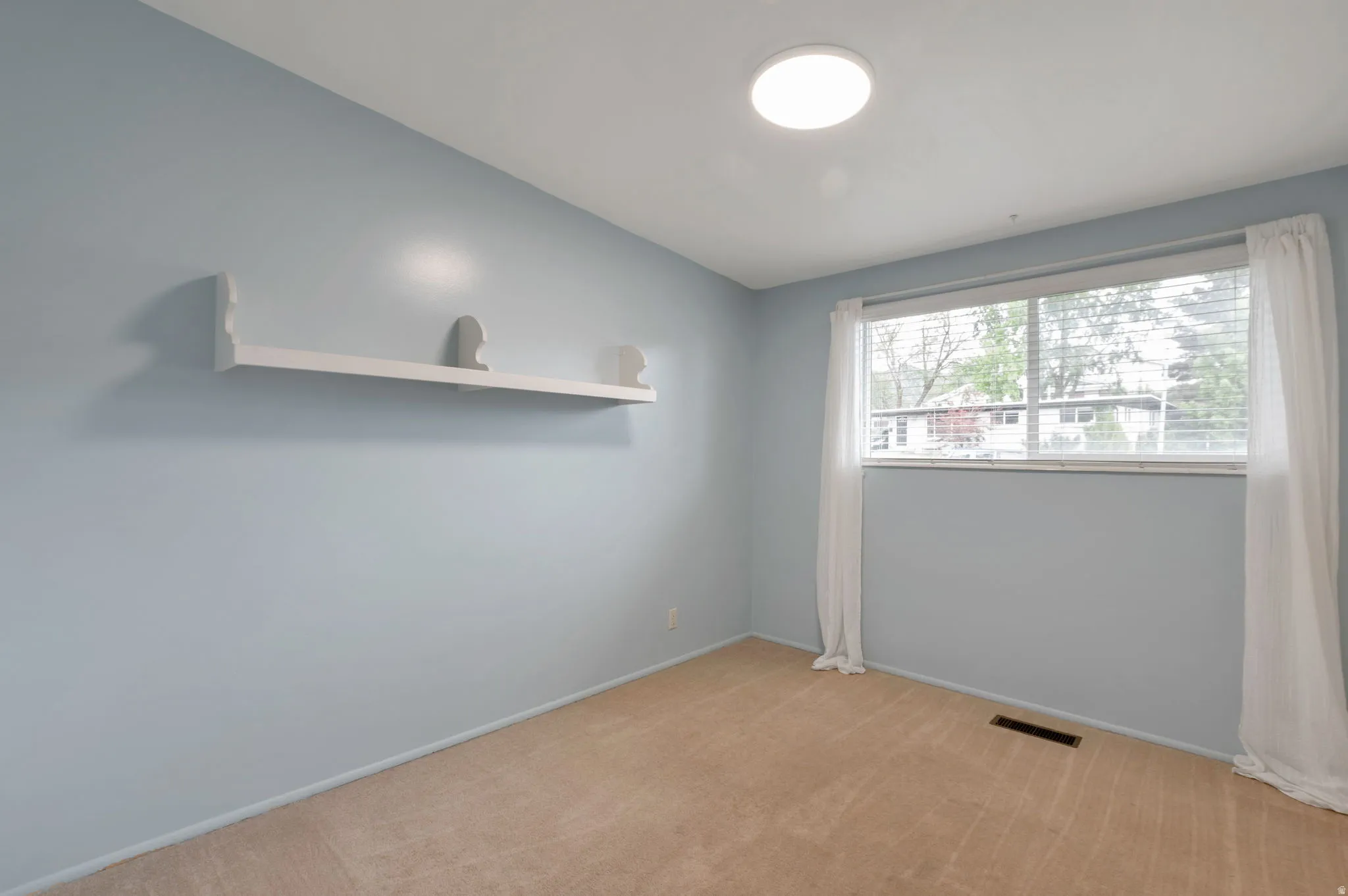 Light blue painted walls with a built-in wall shelf