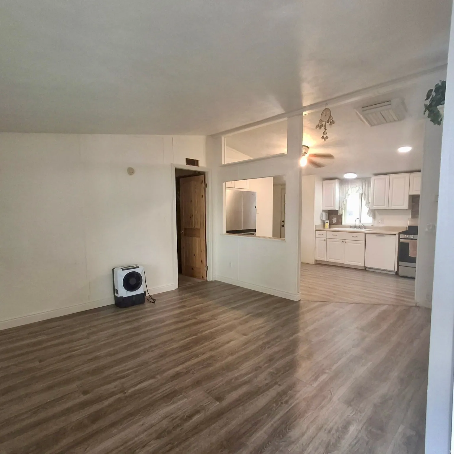 Open concept living area with wood-finish flooring