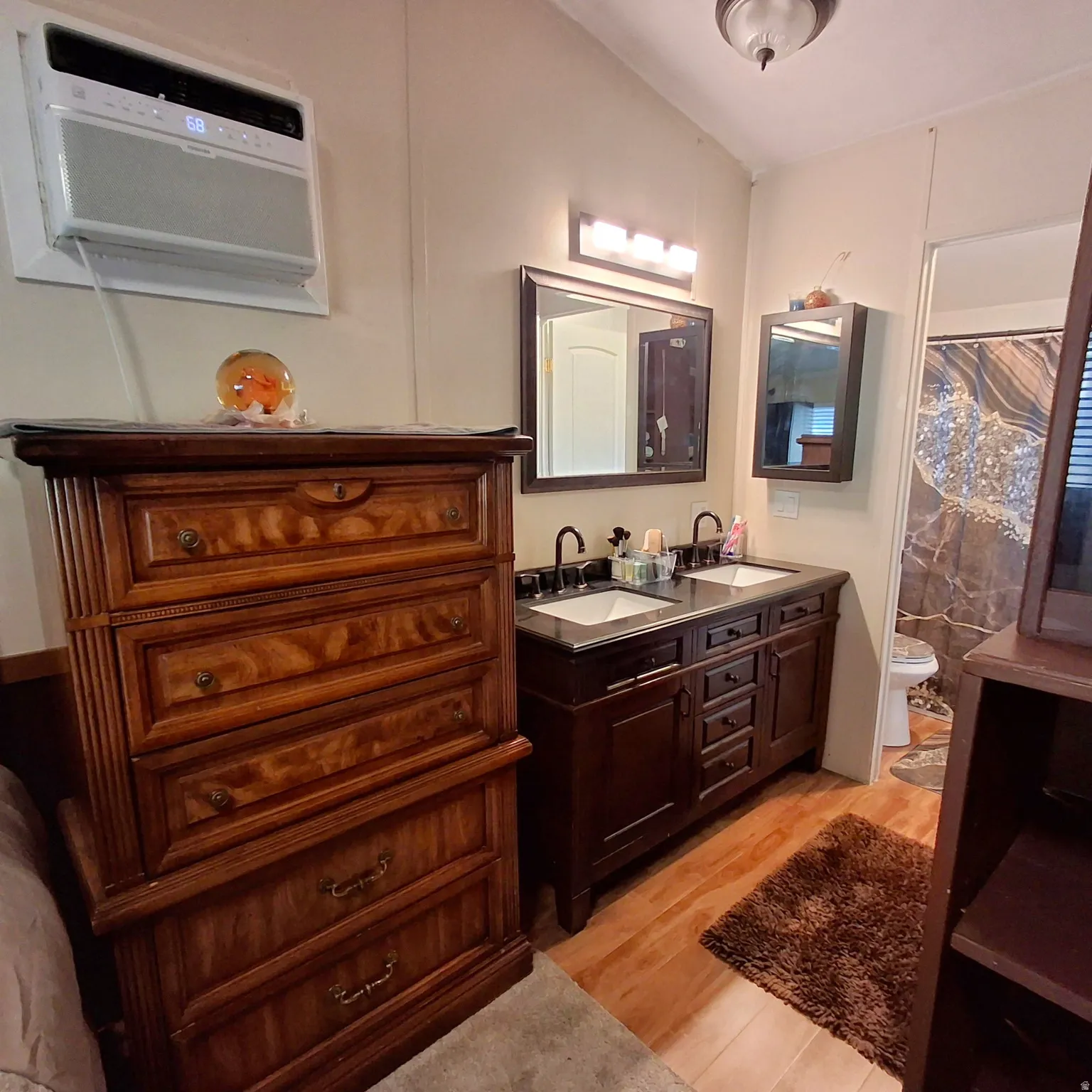 Double vanity with dark cabinetry, dual undermount sinks, and matte black faucets