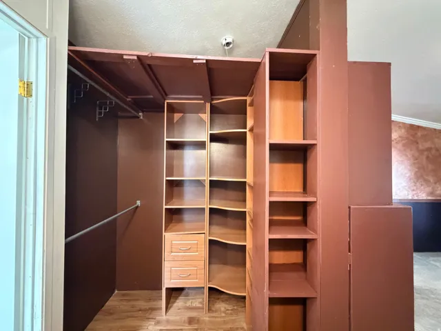 Built-in closet system featuring multiple shelves, hanging rods, and integrated drawers
