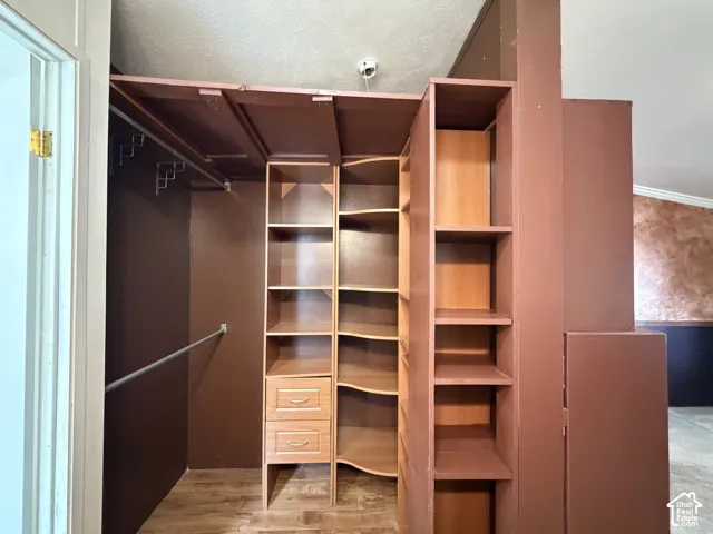 Built-in closet system featuring multiple shelves, hanging rods, and integrated drawers