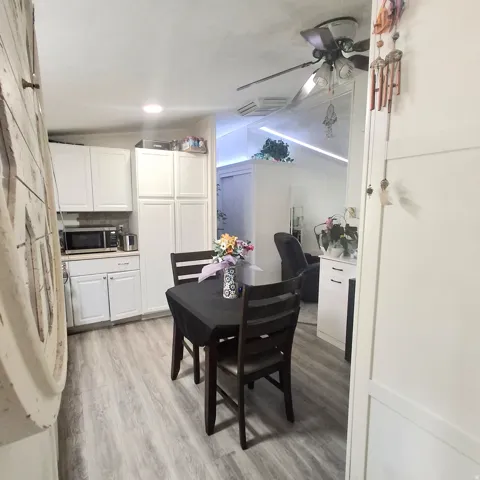 Kitchenette with white shaker cabinetry, light wood-finish flooring, and recessed lighting