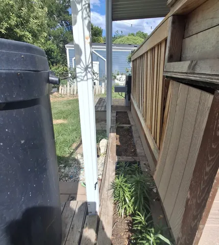 Deck area featuring a wood railing and integrated planter box