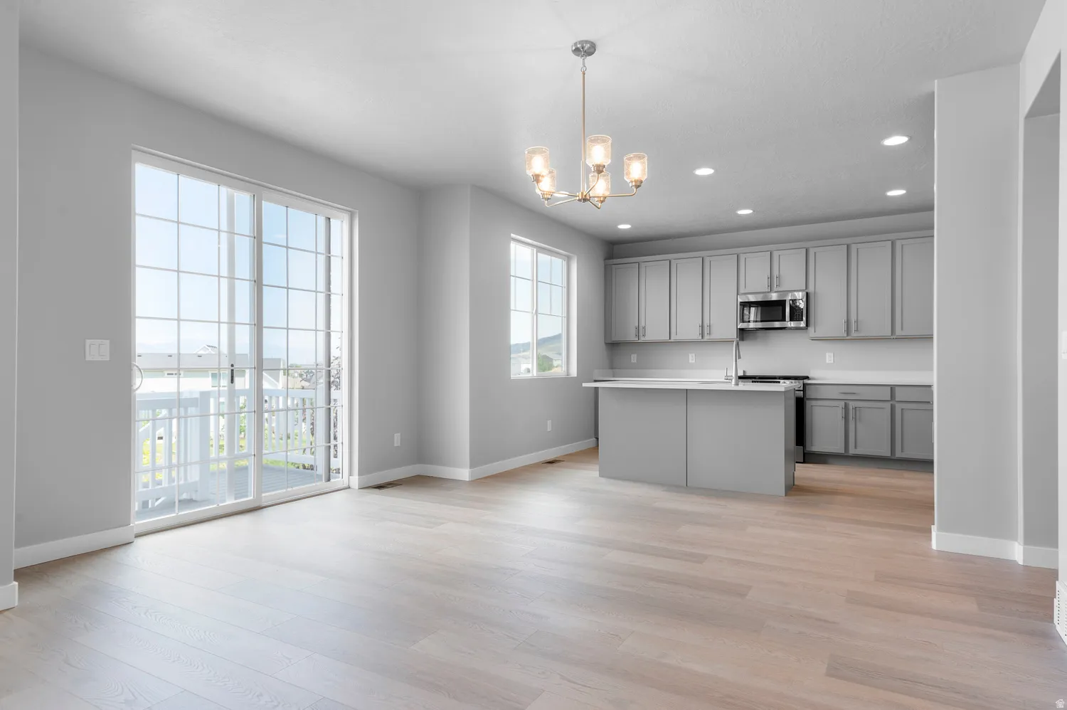 Open-concept living area with wood-finish flooring