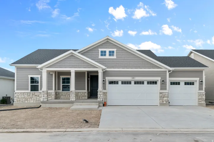 Contemporary ranch-style residence featuring a gray siding and stone veneer exterior