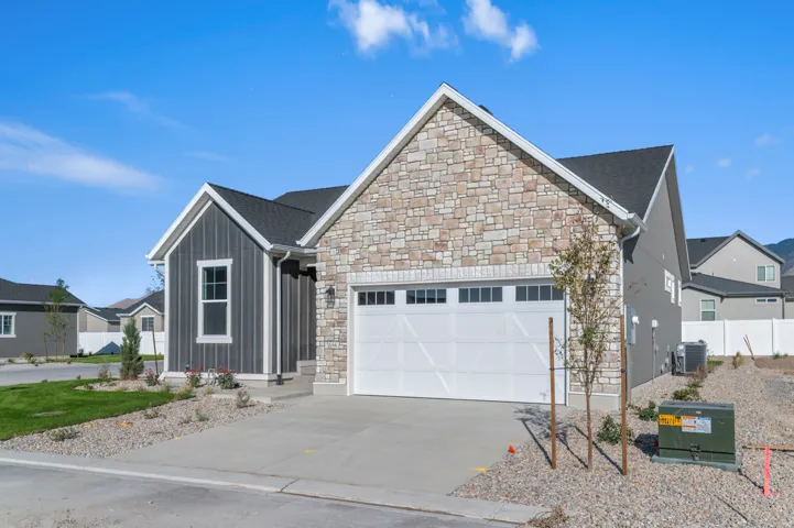Modern exterior featuring stacked stone and vertical siding accents