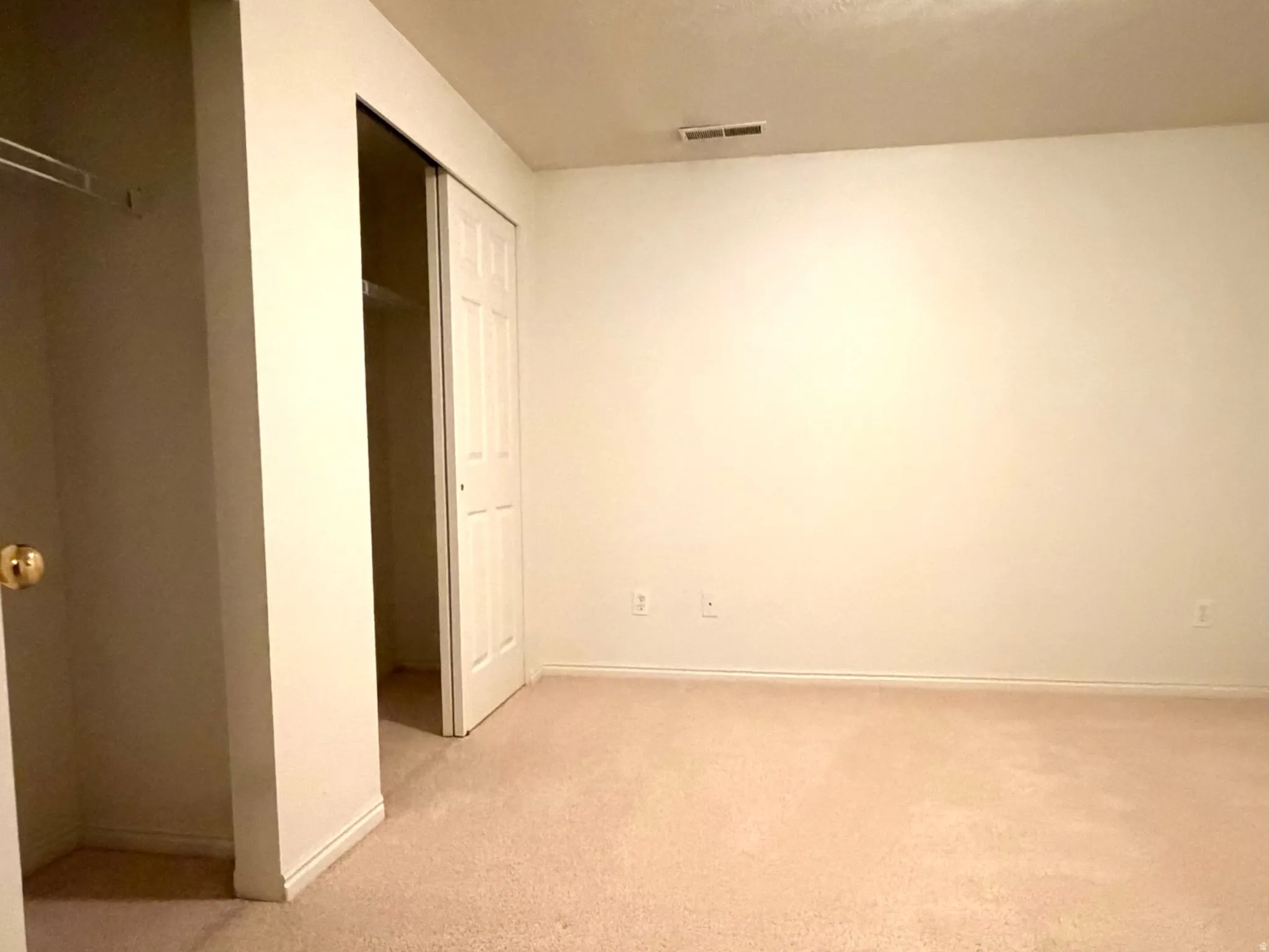 Neutral-toned carpeted room with white walls