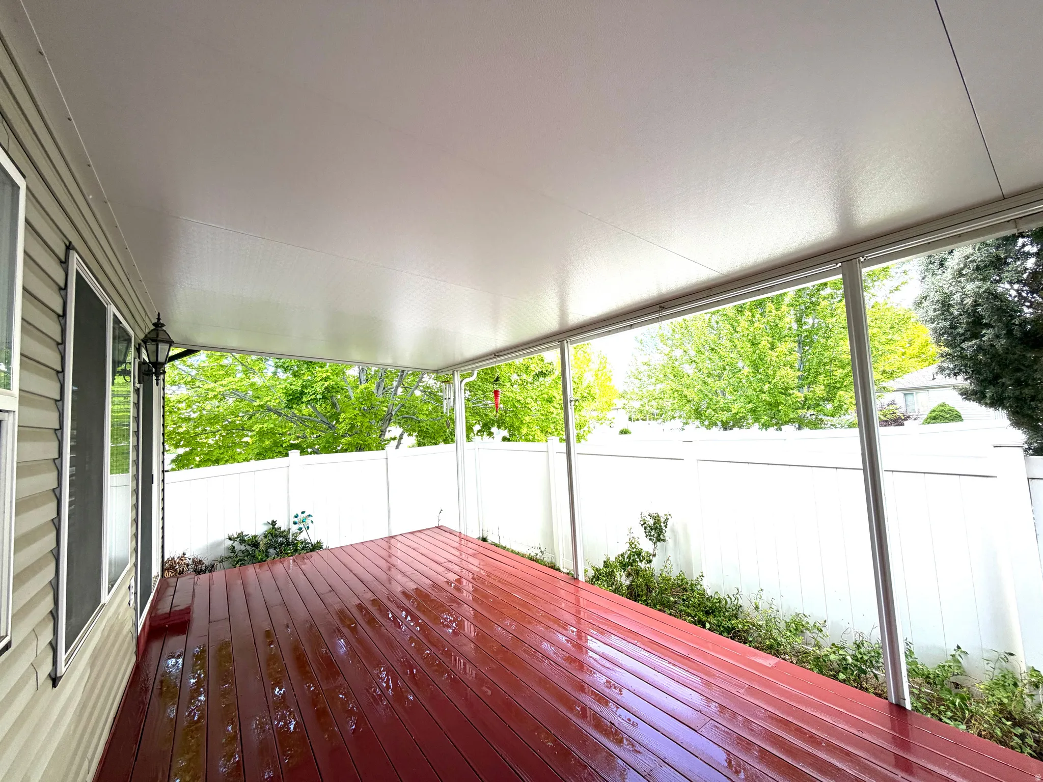 Covered patio with red-toned wood-finish decking