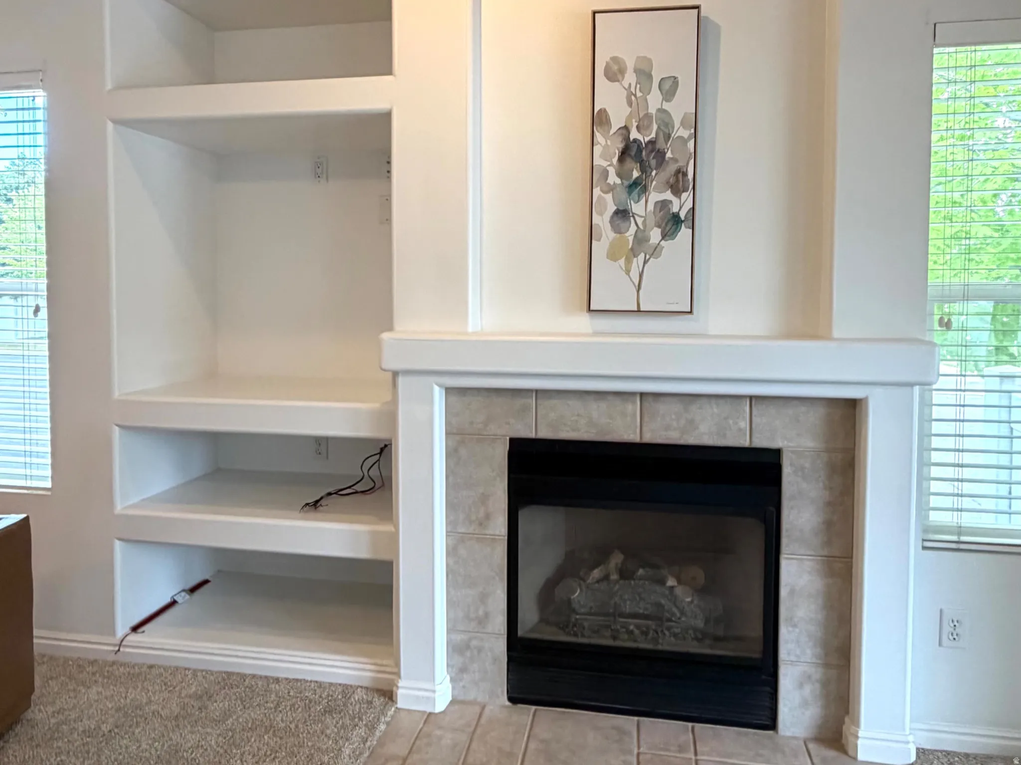 Built-in fireplace with a tile surround and hearth, featuring a white mantel and trim