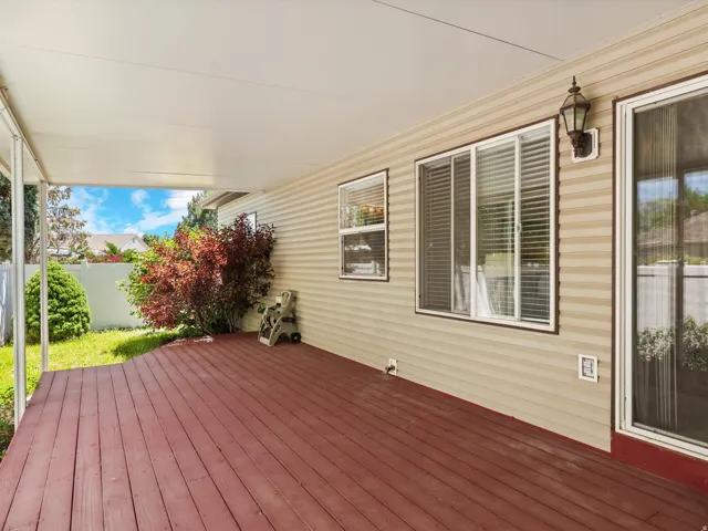Expansive covered patio featuring a rich wood-finish deck