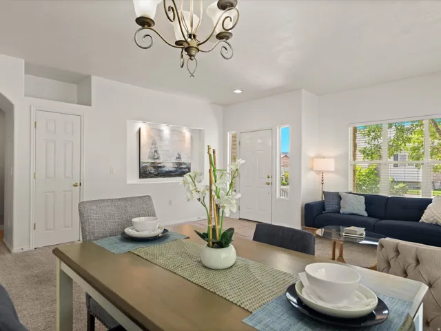 Open-concept dining area featuring a decorative chandelier