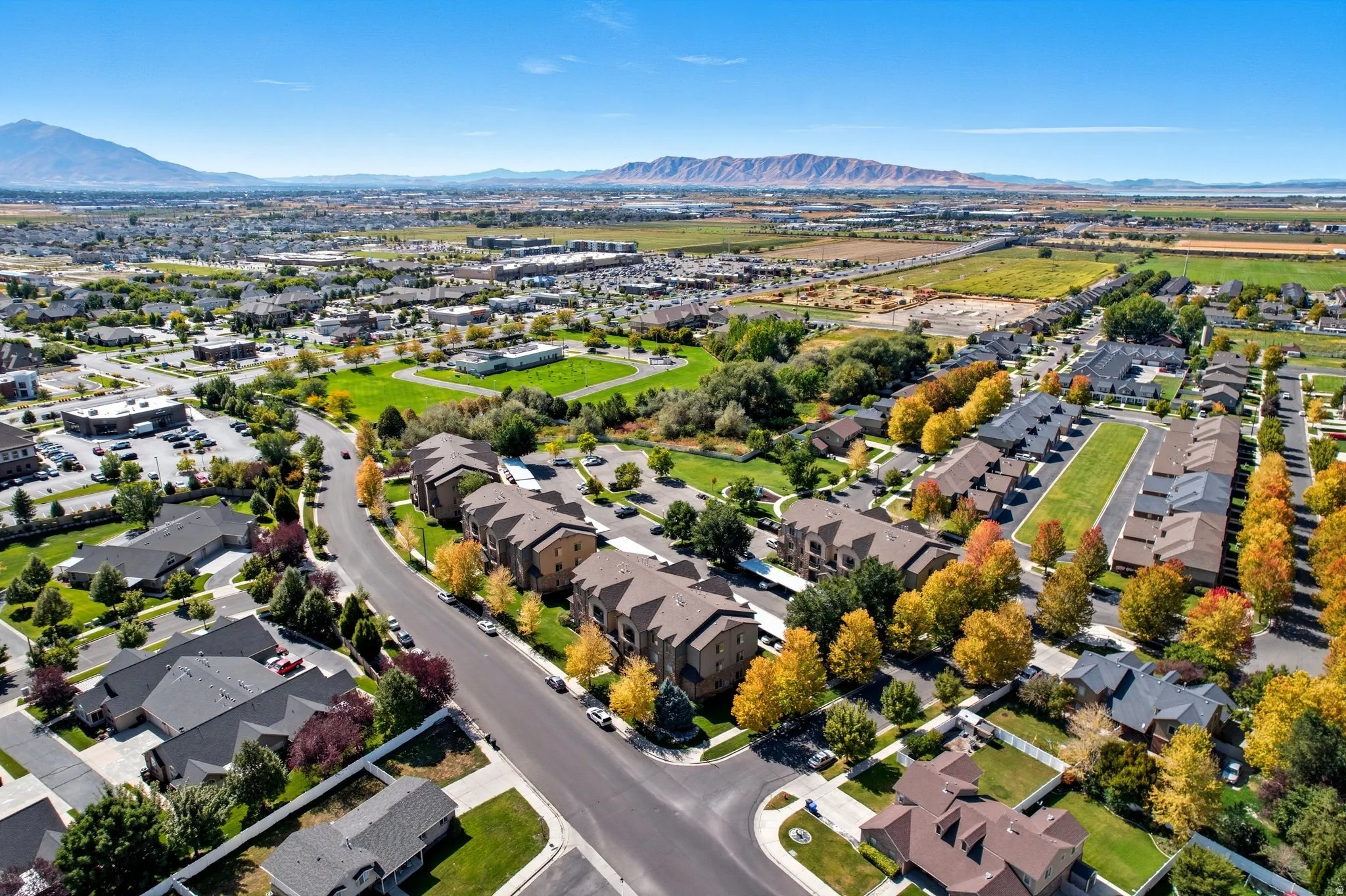 Expansive aerial perspective showcasing a residential community with varied a mountain range backdrop