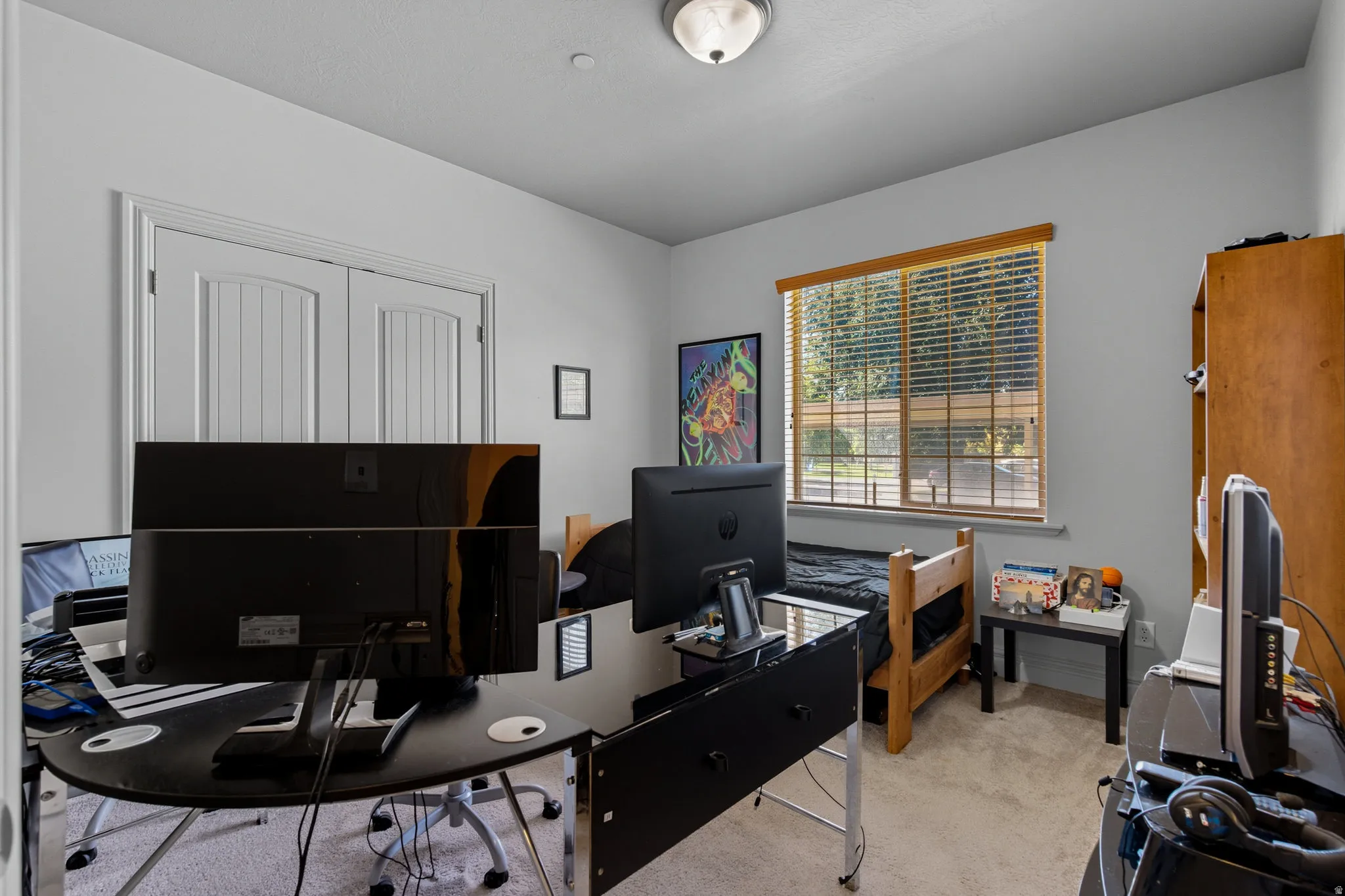 Carpeted interior featuring light gray walls and a ceiling-mounted light fixture