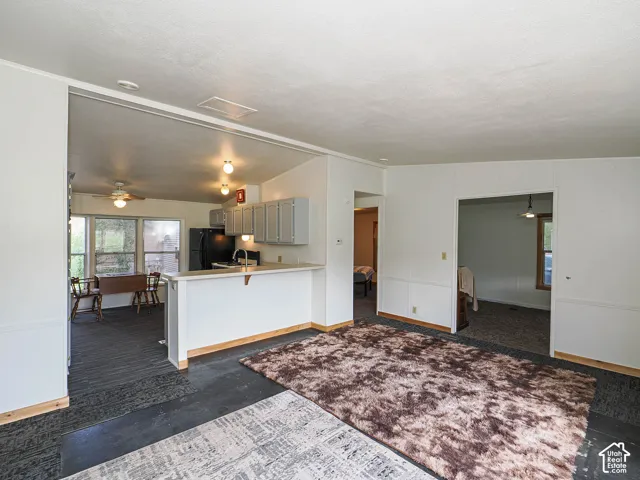 Open-concept living space featuring a partial wall separating the kitchen area