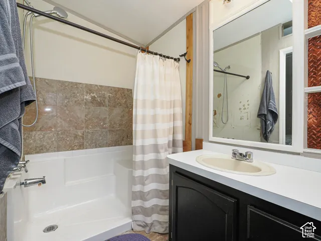 Bathroom featuring a white bathtub and shower combination with stone-look tile surround