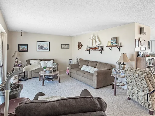Neutral-toned walls complement the light-colored carpeting