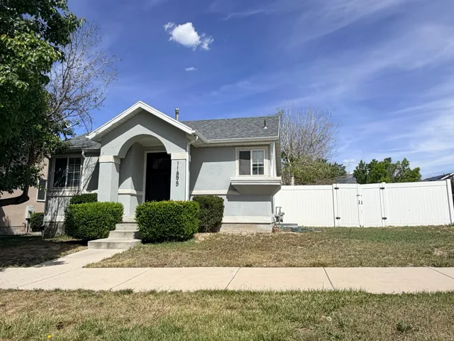 Front exterior featuring a covered entry porch, bay window, and a white privacy fence