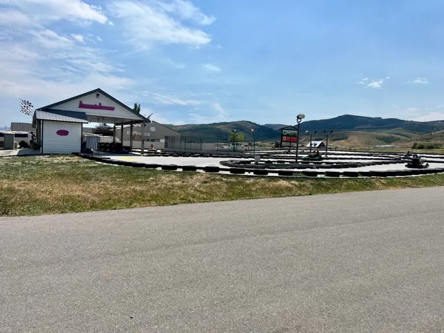Go-kart track featuring a paved surface and tire barriers