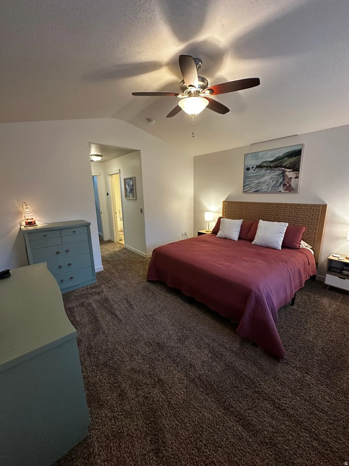 Spacious room with plush carpeting and a ceiling fan with integrated lighting