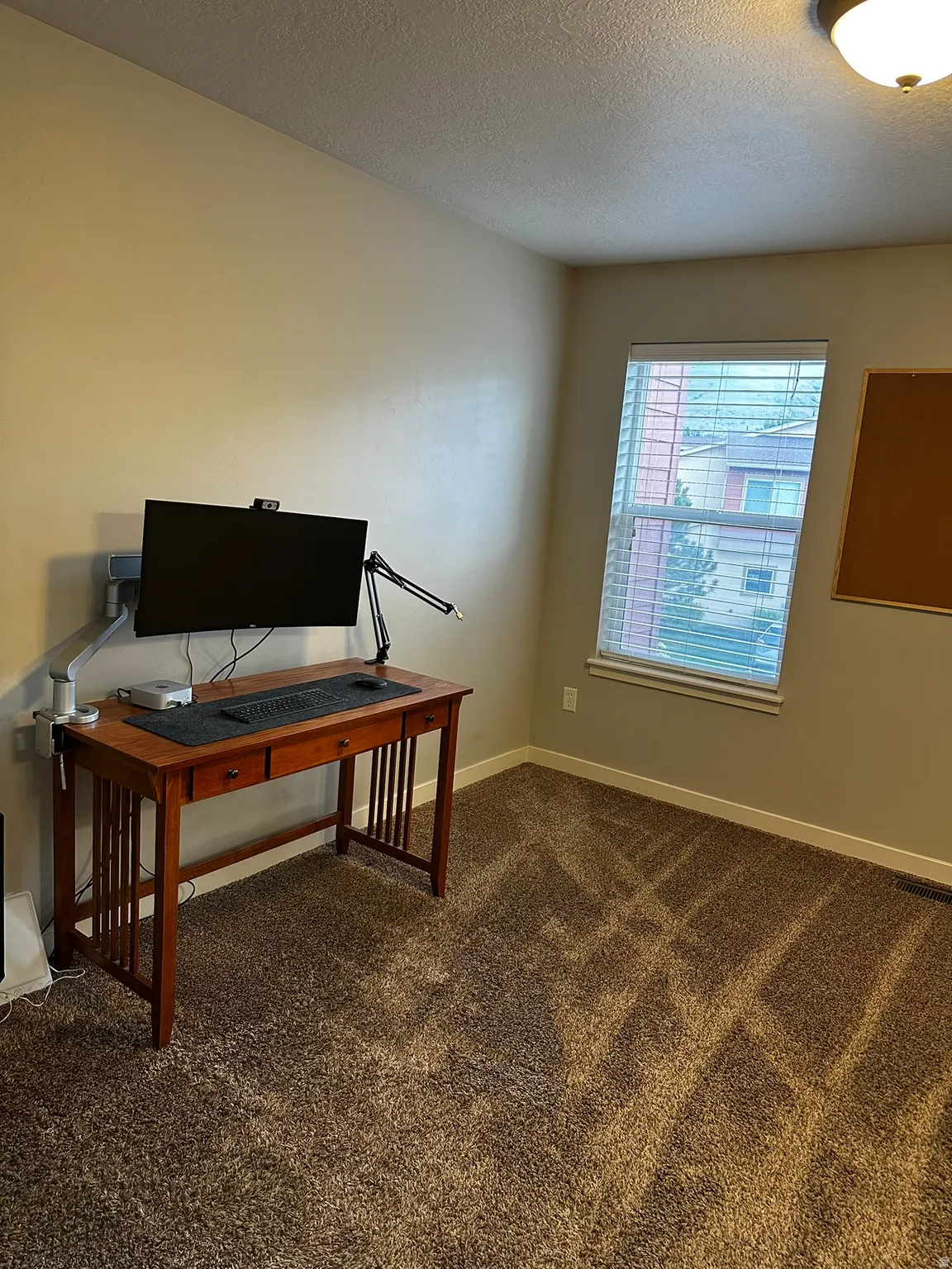 Neutral wall color with a built-in window and brown carpet flooring