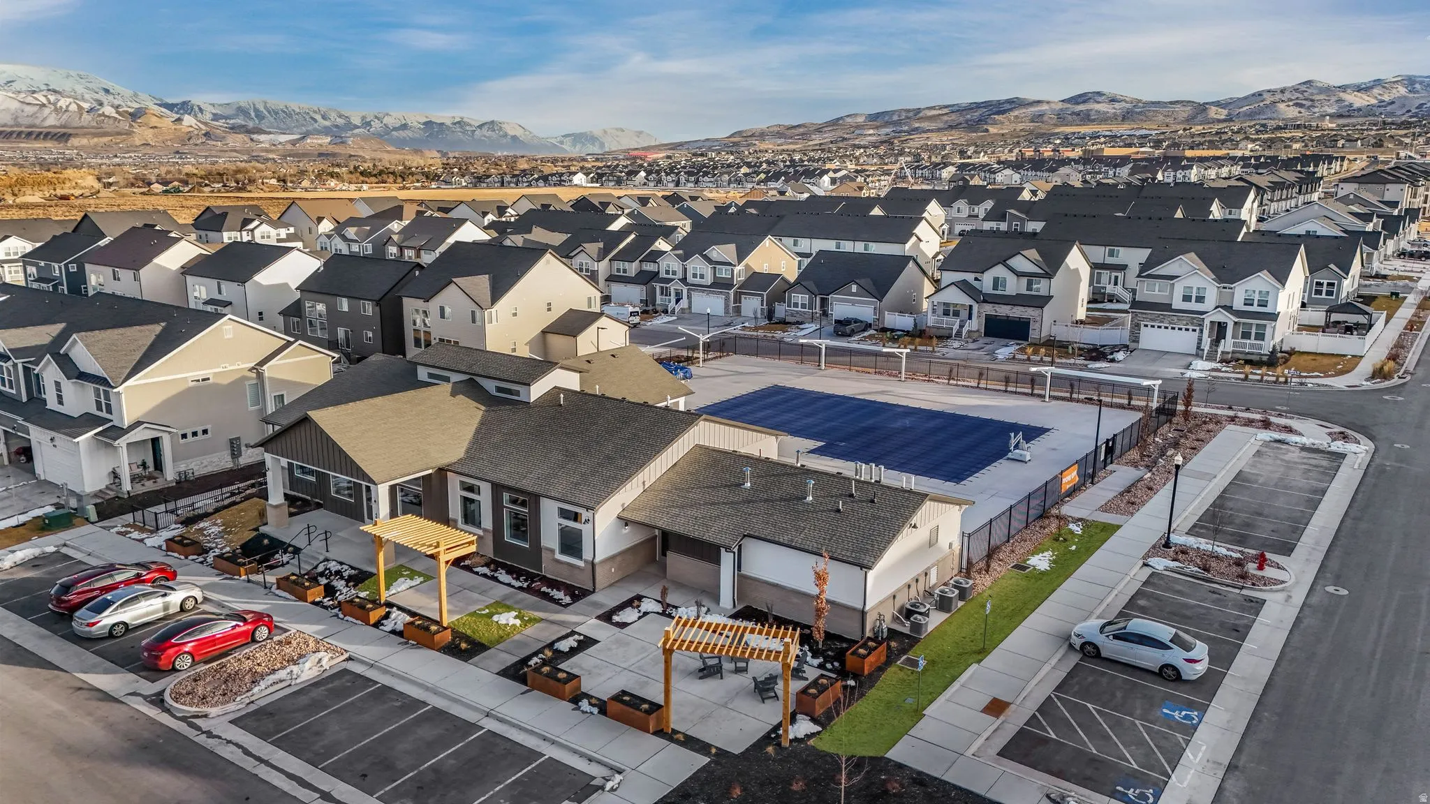 Community clubhouse with an outdoor pool area and surrounding residential properties