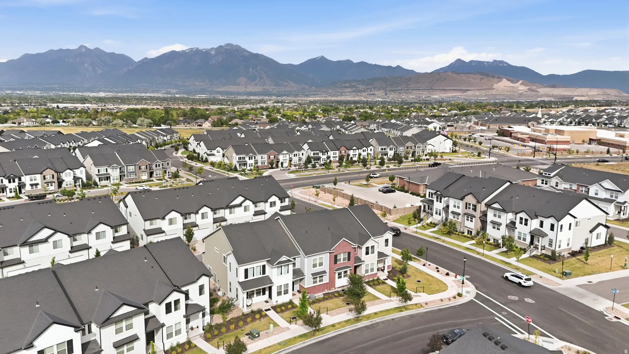 Residential community featuring various architectural styles, paved roadways, and mature landscaping