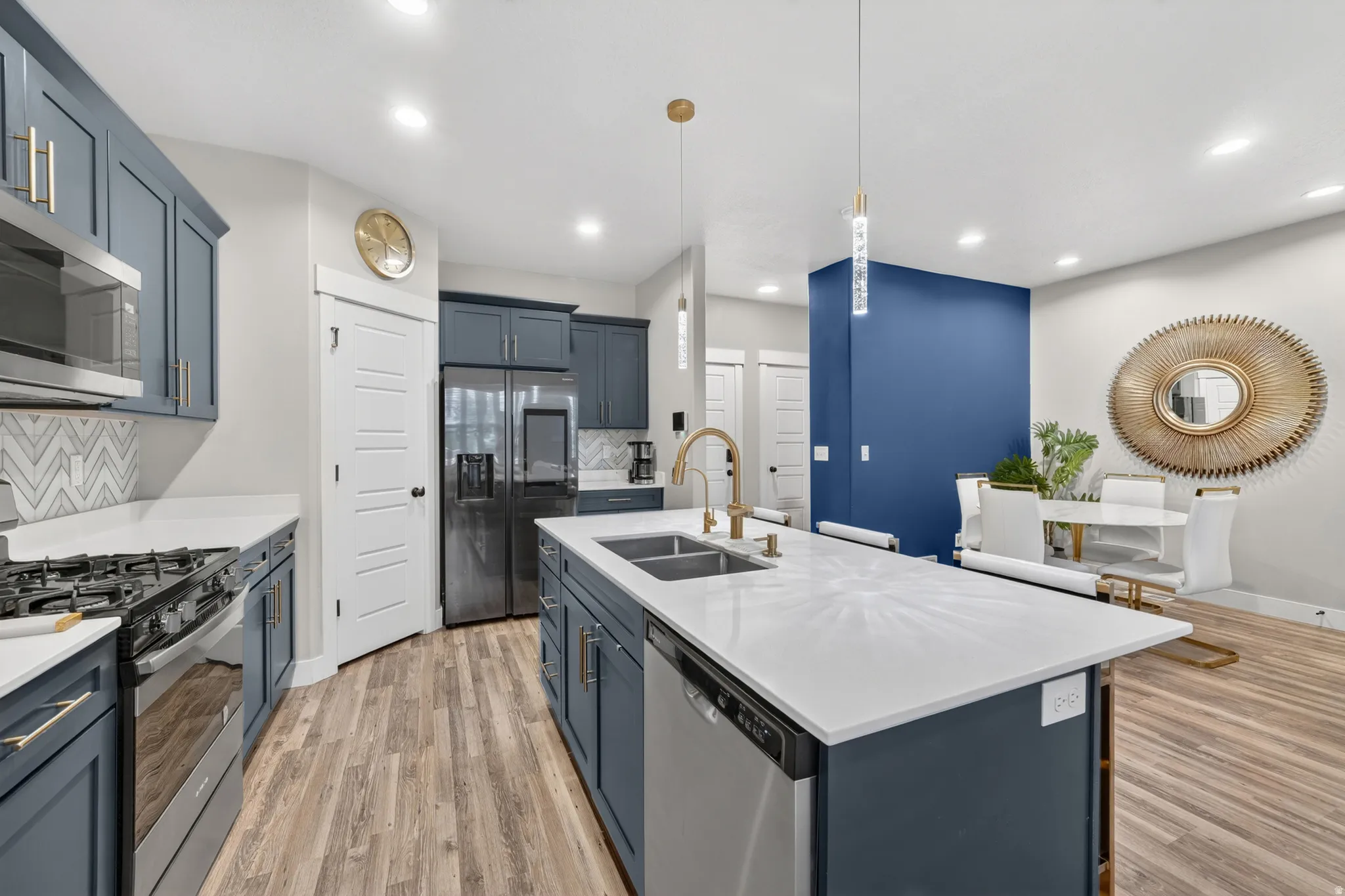 Open-concept kitchen and dining area with contemporary blue cabinetry