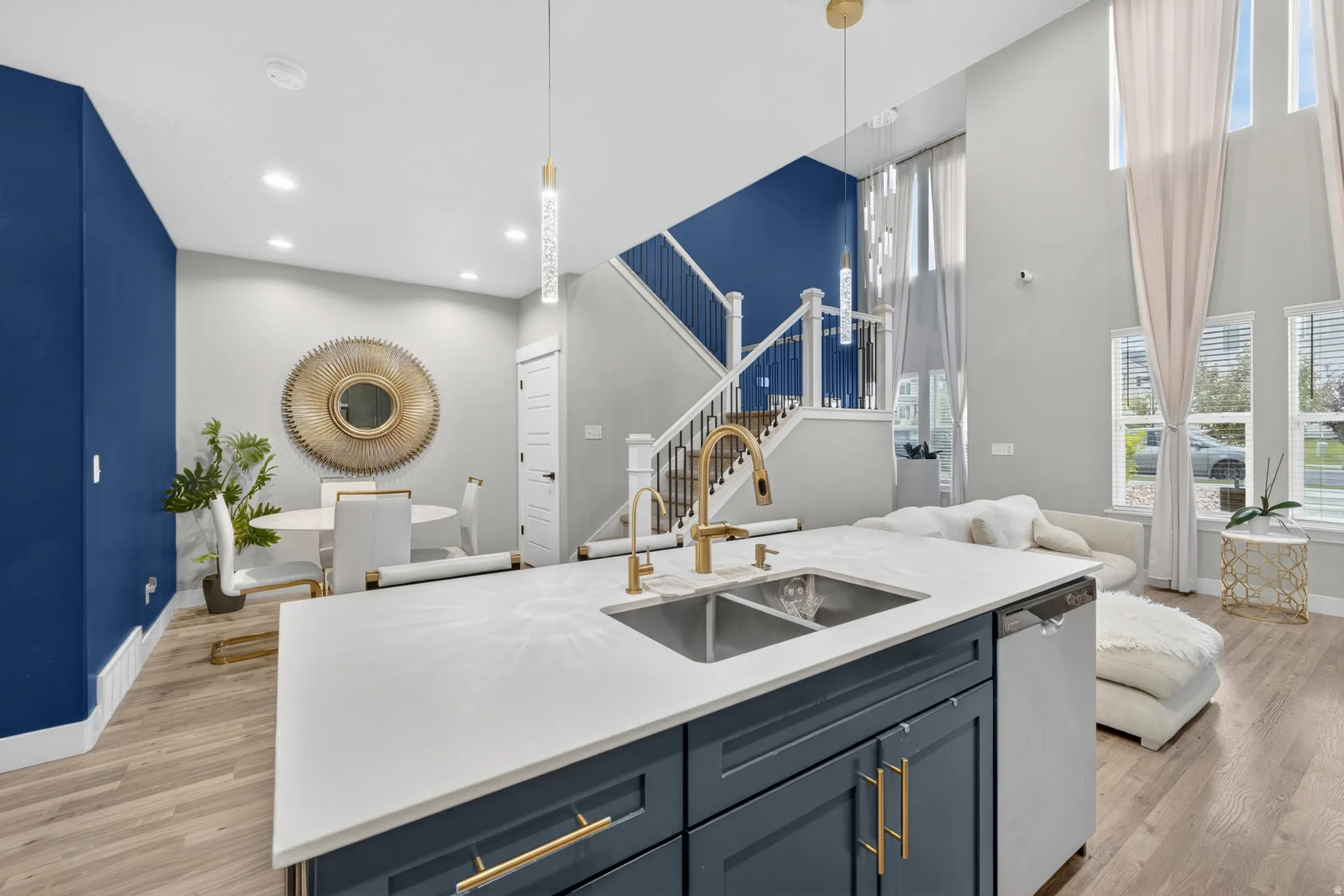 Kitchen island featuring a double-basin stainless steel sink with gold-tone hardware