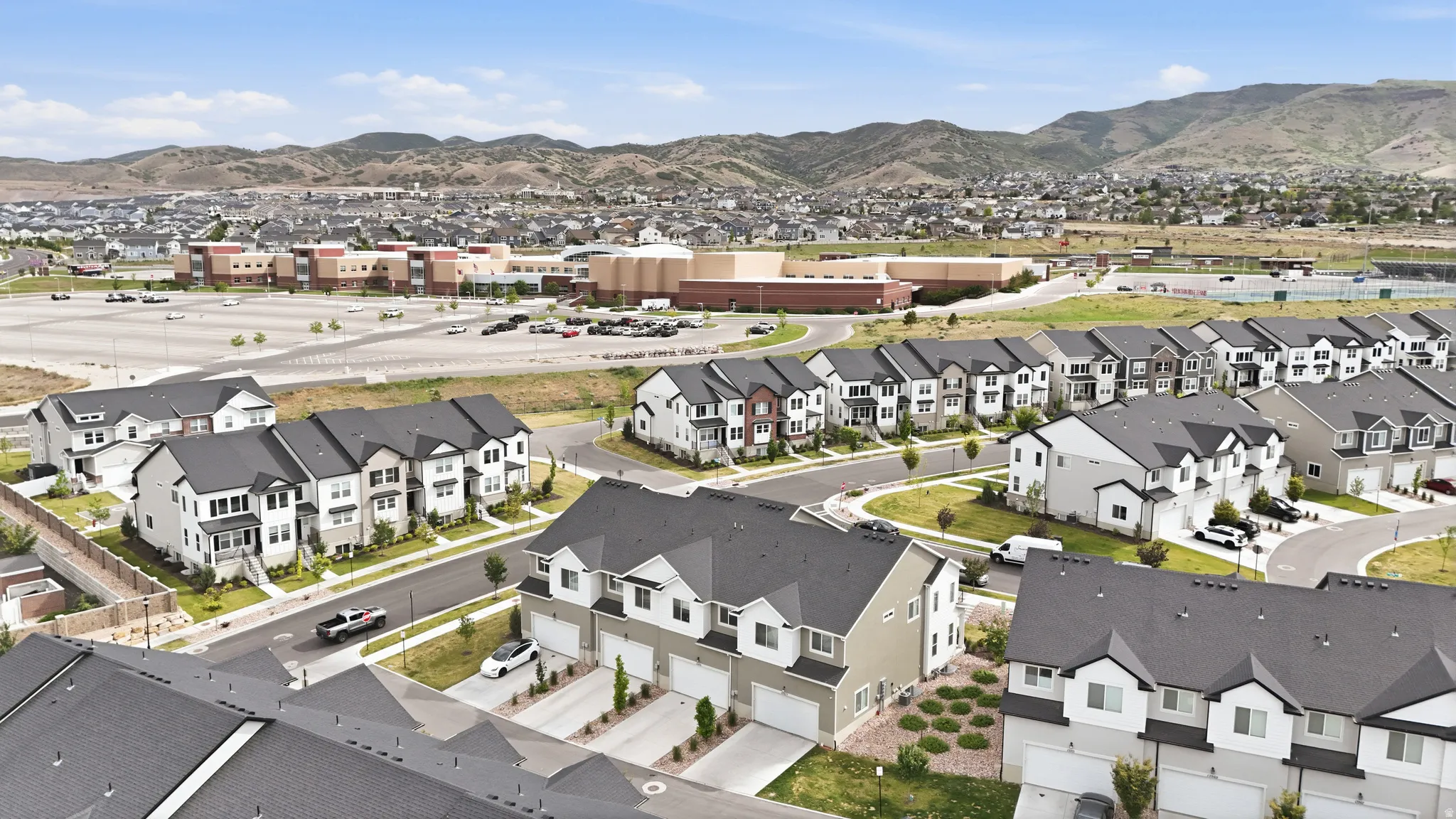 Neighborhood featuring multi-story residences with dark roofs and light-colored siding