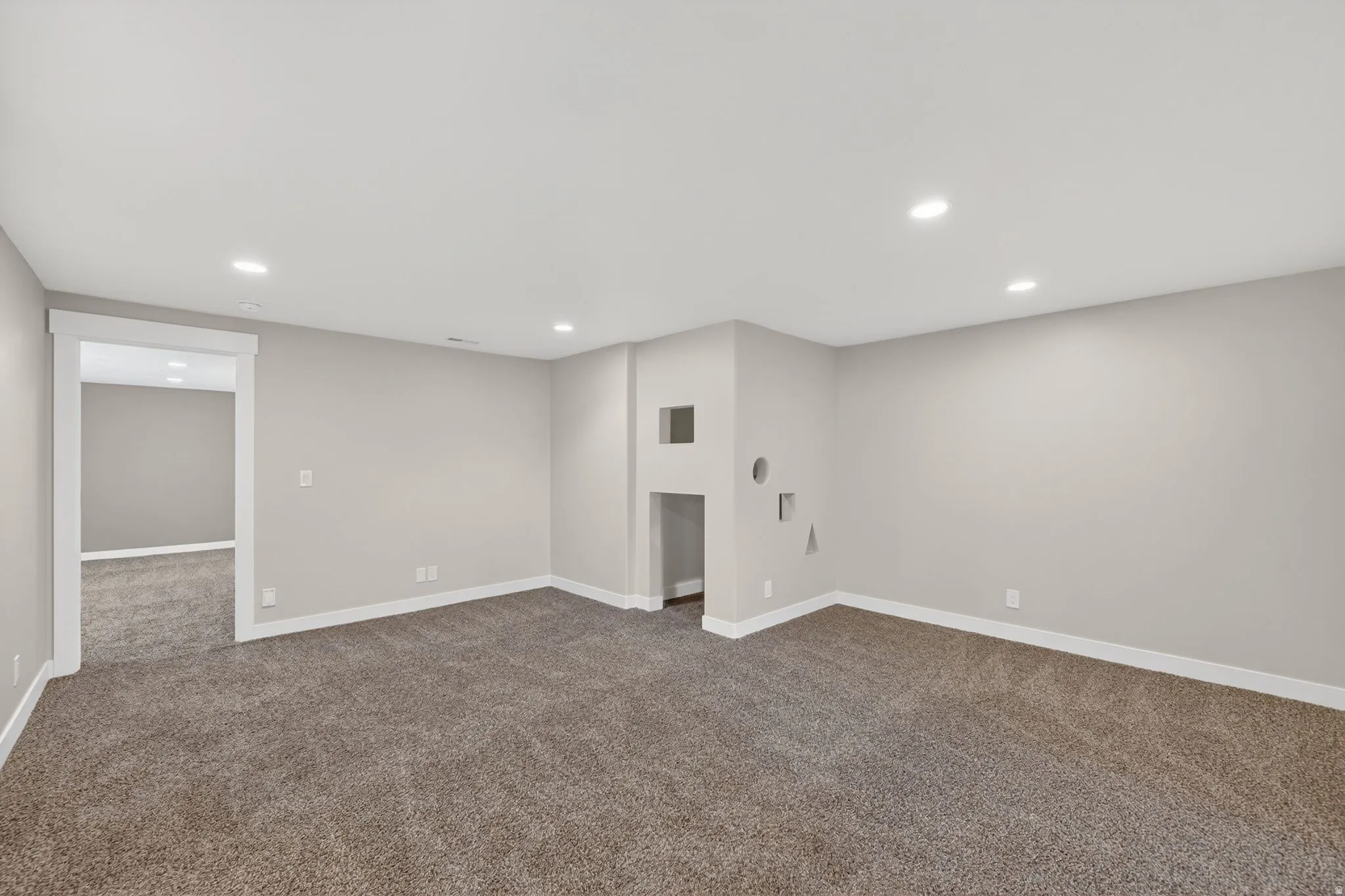 Spacious room featuring neutral carpeting and light-toned walls