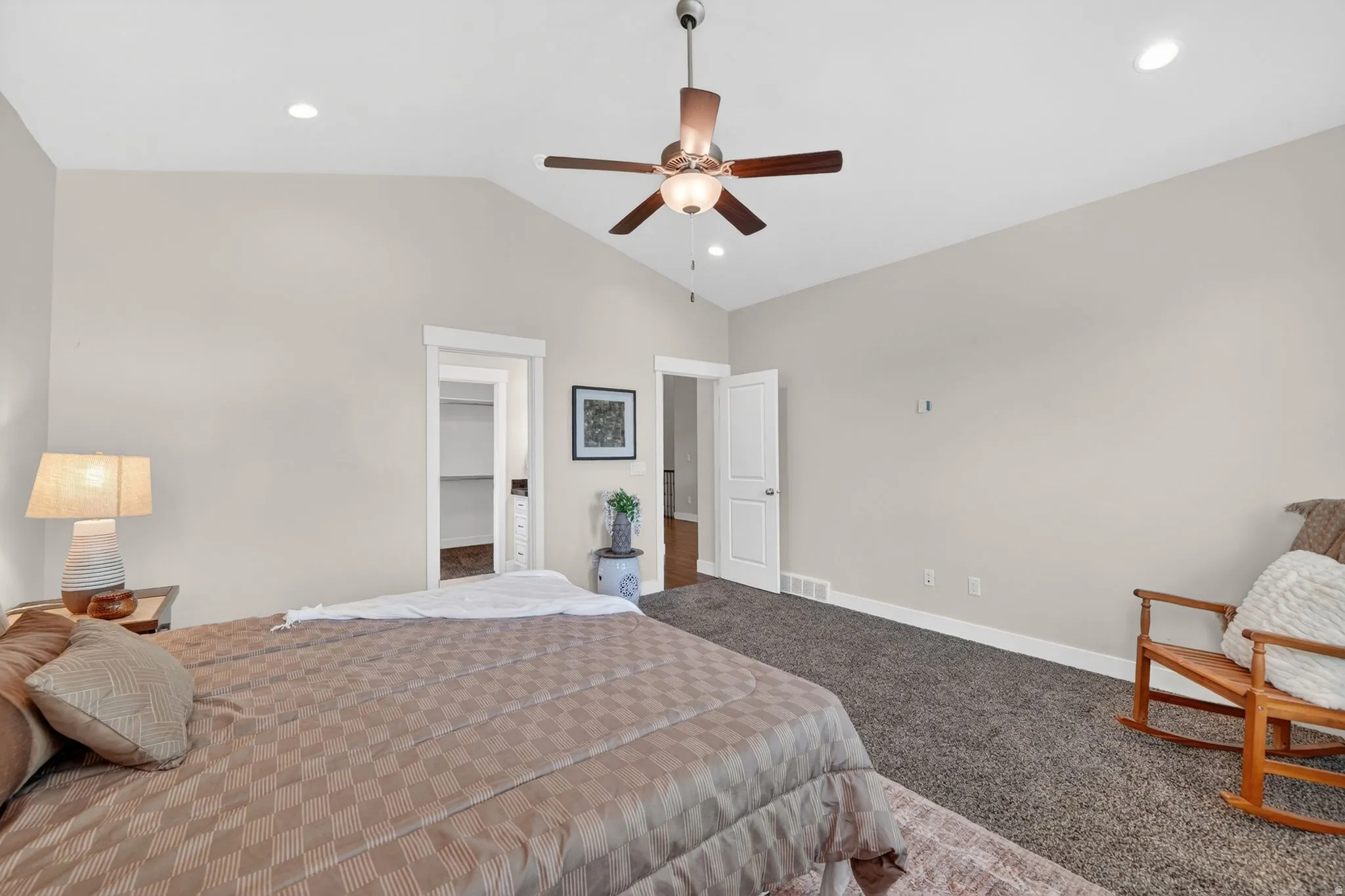 Vaulted ceilings featuring a ceiling fan with integrated lighting, recessed lighting, and soft gray wall tones