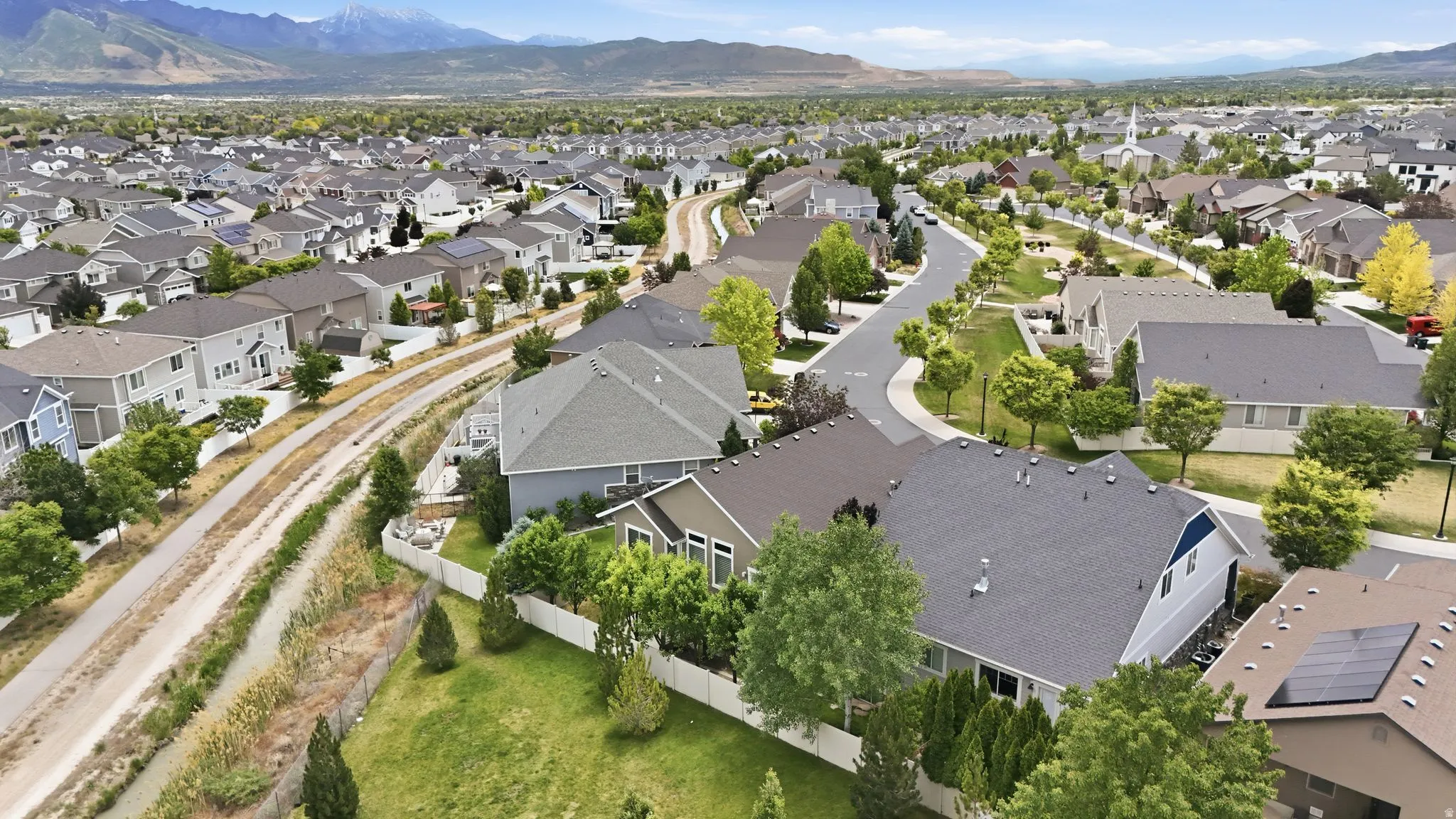 Aerial perspective showcasing a residential area with varied home styles and surrounding natural features