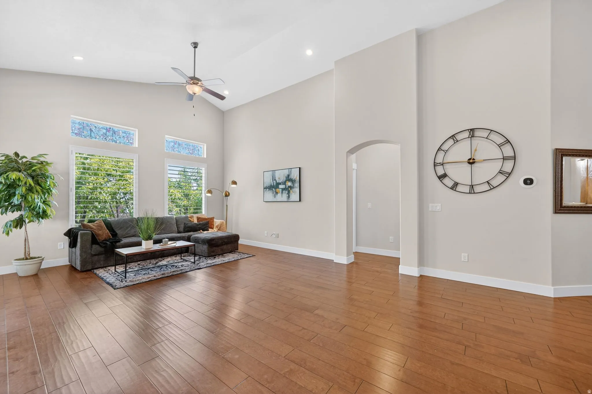Spacious living area featuring high vaulted ceilings.