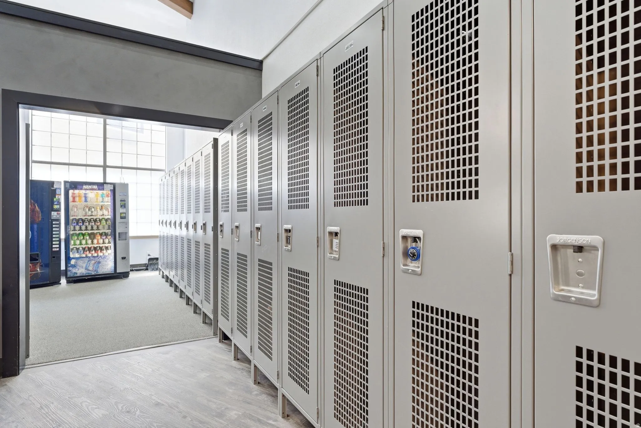 Row of light gray metal lockers with perforated panels