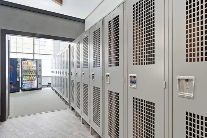 Row of light gray metal lockers with perforated panels