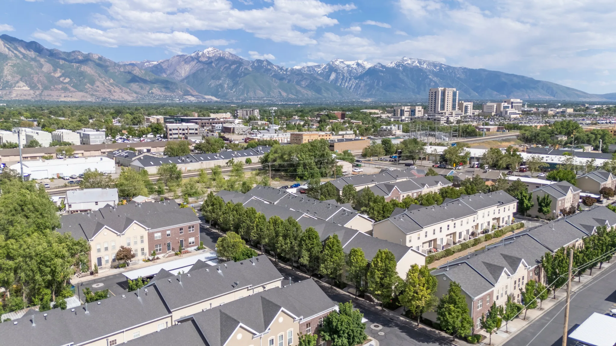 Aerial perspective of a multi-unit residential development with a mountain backdrop