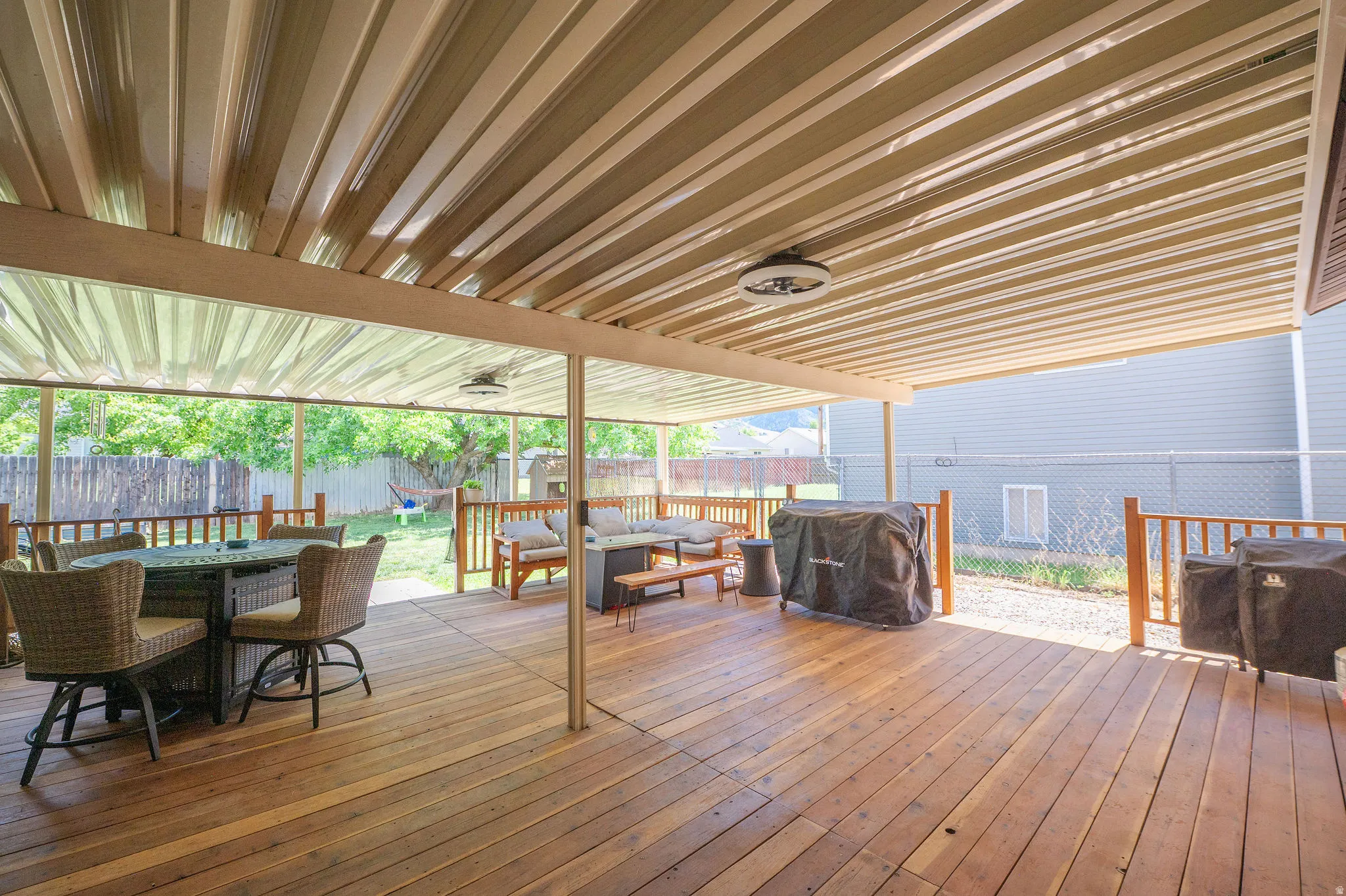 Expansive covered wooden deck perfect for shade during the summer days, rainy nights, and entertaining!