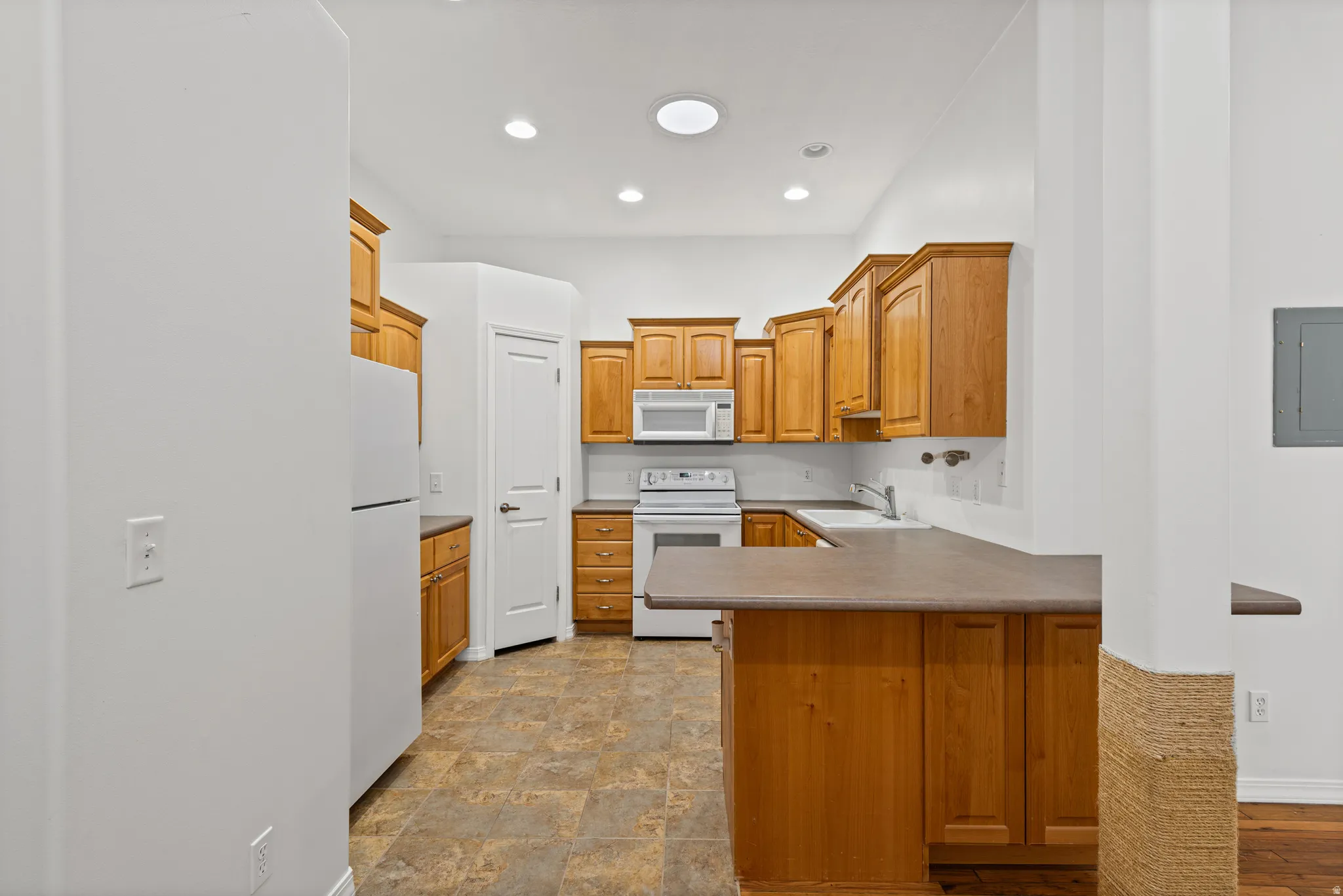 Kitchen featuring wood cabinetry with all appliances included