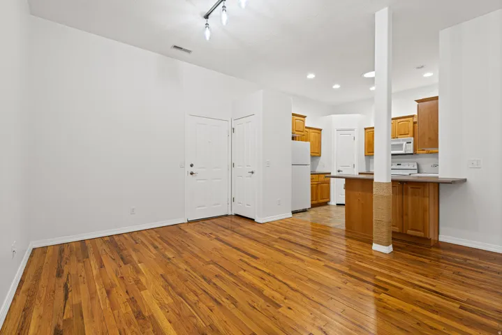 Spacious  living space looking into the kitchen