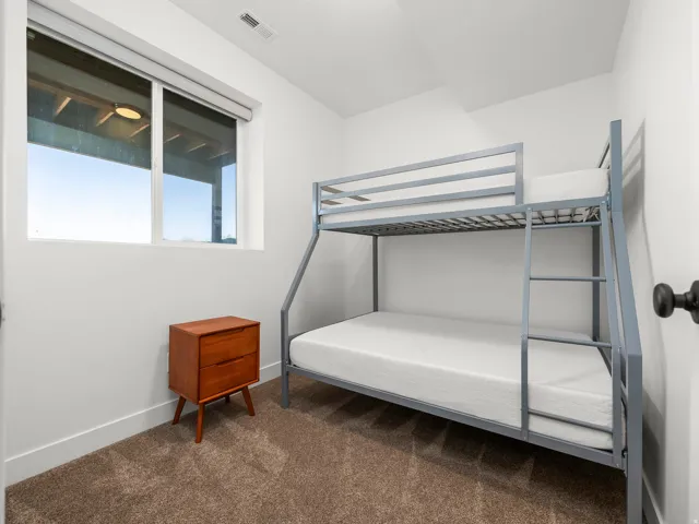 Bright room featuring a large window with roller shades