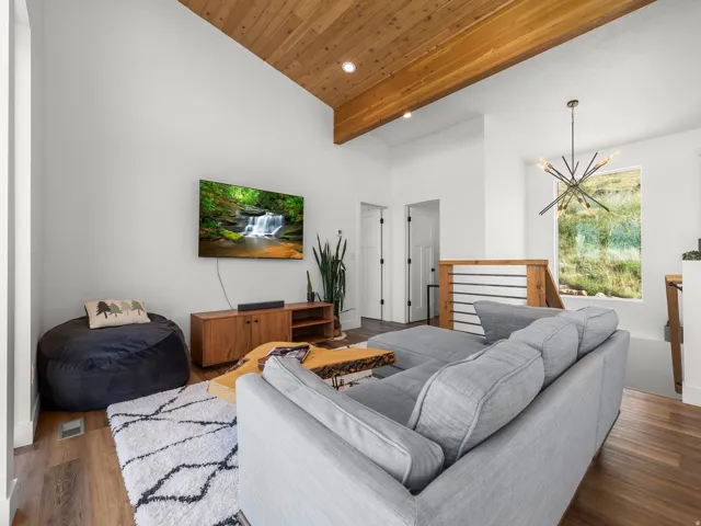 Living area featuring a vaulted wood-finish ceiling, recessed lighting, and wood-finish flooring