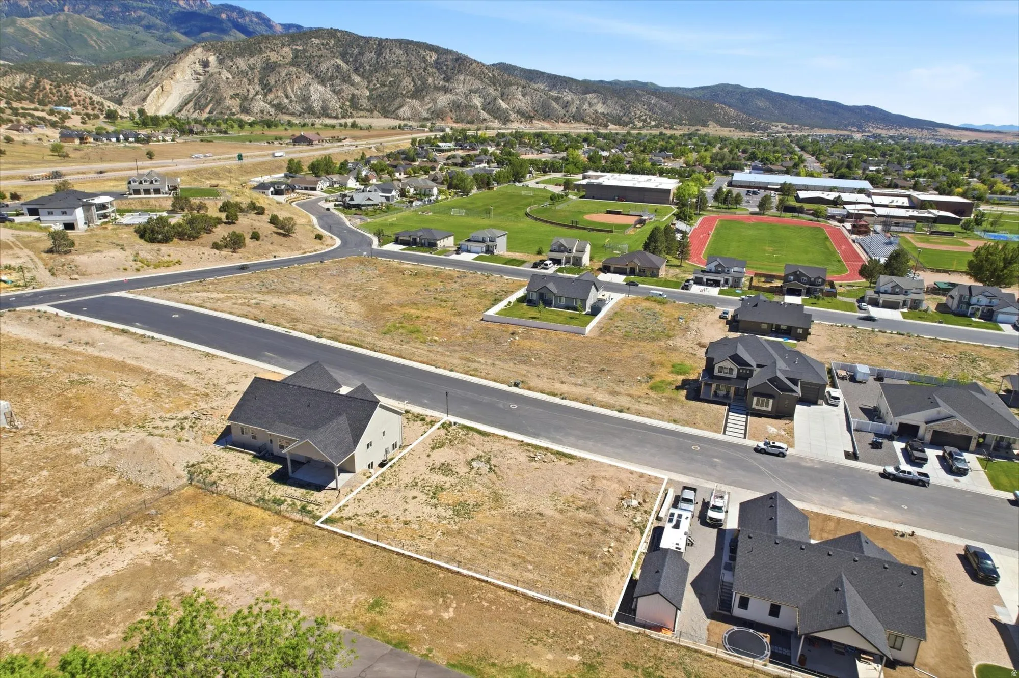 Aerial perspective showcasing multiple residential lots with mountain backdrop